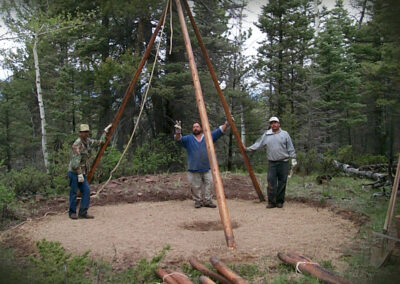 Raising the 18’ tall tipi with spruce poles harvested from our land – erected over the center fire pit.