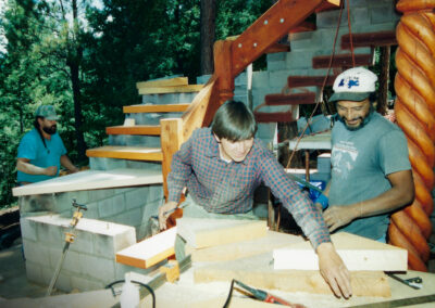 Mike and Tom, along with award-winning Taos wood carver Paul Martinez, building the north, outdoor heavy-beam staircase.