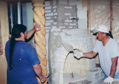Tom and John building the third floor kiva fireplace in the Taos Pueblo style.
